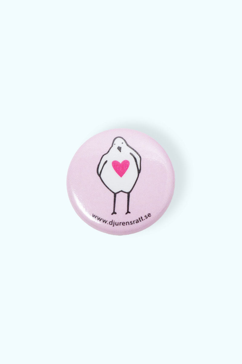 Rosa liten pin med illustration av en kyckling